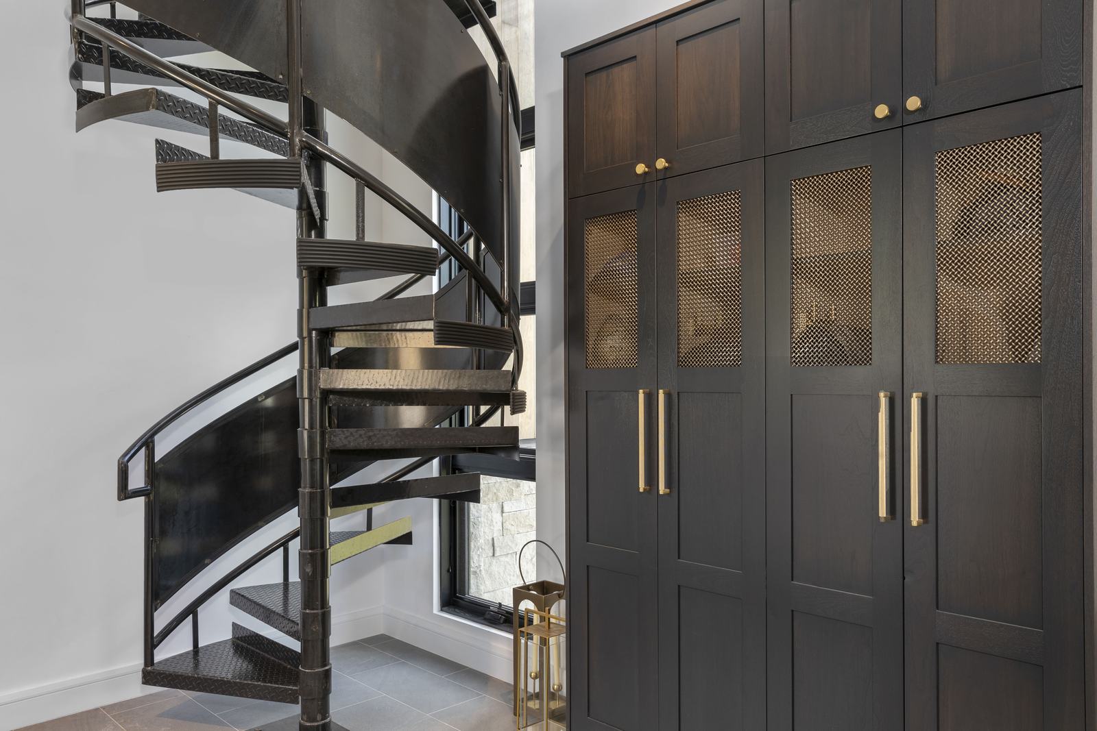 Spiral stair and millwork at 114 Lawson Overlook, built by UltraBuilders in Mountain Village, Colorado